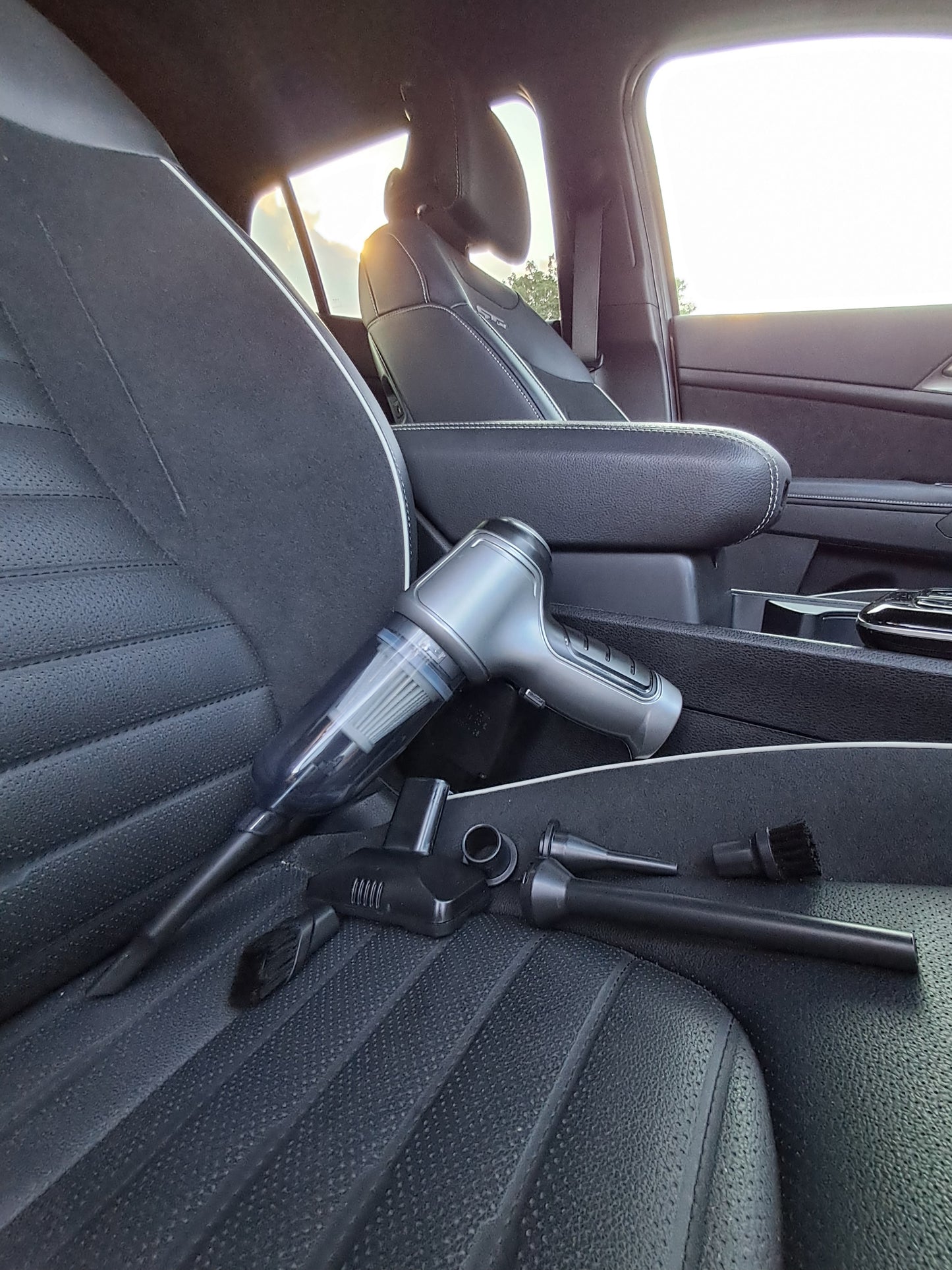 Car interior with a vacuum cleaner on the back seat